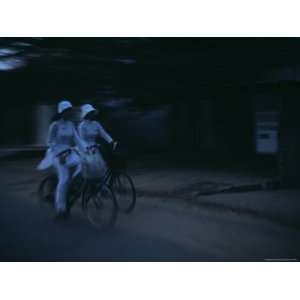 Girls in Traditional Vietnamese Ao Dai, Cycle to School Before Dawn 