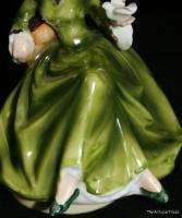   Japanese porcelain figurine Lady in Green holding a bird music box